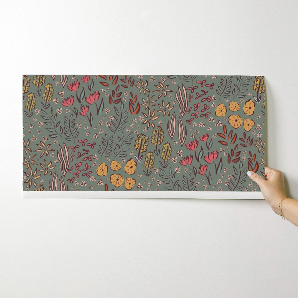 Floral patterned mat held by a hand on a white background