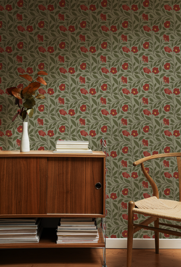 Room interior with wooden cabinet, chair, and green floral wallpaper